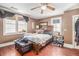 This bedroom has wood floors, a ceiling fan and windows that let in natural light at 204 Emory St, Oxford, GA 30054