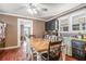 Sun-drenched dining area featuring a long wooden table, wood floors, and classic decor at 204 Emory St, Oxford, GA 30054