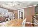 Bright dining area showcasing a large wooden table, wood floors, and ample space for Gathering gatherings at 204 Emory St, Oxford, GA 30054