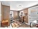 Inviting room with tiled floor, stylish rug, and a vintage cabinet, blending old and new charm at 204 Emory St, Oxford, GA 30054