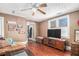 Cozy living room featuring wood floors, a ceiling fan, and decor, creating a welcoming atmosphere at 204 Emory St, Oxford, GA 30054