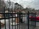 Gated community entrance featuring wrought iron fencing and brick pillars for added security and privacy at 3236 Abbeywood Dr, Decatur, GA 30034