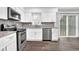 Modern kitchen with stainless steel appliances, gray backsplash, and sleek white cabinets at 3236 Abbeywood Dr, Decatur, GA 30034