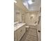 Bright bathroom featuring a marble vanity, tub, updated fixtures and a decorative rug at 3777 Peachtree Ne Rd # 733, Atlanta, GA 30319