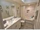 Bright bathroom featuring a marble vanity, tub, updated fixtures and a decorative rug at 3777 Peachtree Ne Rd # 733, Atlanta, GA 30319