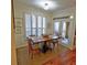 Bright dining area with a wooden table, neutral walls, and a door leading to a patio at 3777 Peachtree Ne Rd # 733, Atlanta, GA 30319