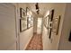 Hallway showcasing the art collection with a decorative rug and leading to the bathroom at 3777 Peachtree Ne Rd # 733, Atlanta, GA 30319