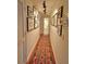 Hallway with decorative rug, wood floors and gallery wall at 3777 Peachtree Ne Rd # 733, Atlanta, GA 30319