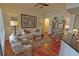 Cozy living room featuring hardwood floors, ceiling fan, and an assortment of chairs, tables, and decor at 3777 Peachtree Ne Rd # 733, Atlanta, GA 30319