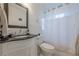 Bathroom featuring a dark granite countertop, classic white subway tile, and elegant white shower curtain at 1195 Cameron Ne Ct, Atlanta, GA 30306