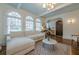 Elegant living room with arched windows, a plush white sofa, and a stylish marble coffee table at 1195 Cameron Ne Ct, Atlanta, GA 30306