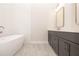 Bright bathroom with double vanity, modern tub, and tile flooring at 275 Briscoe Way # 3, Alpharetta, GA 30009