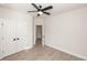 Bright bedroom featuring a modern ceiling fan, wood-look floors, and ample closet space at 275 Briscoe Way # 3, Alpharetta, GA 30009