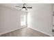 Bedroom with a bright window, grey wood-look floors, and neutral paint at 275 Briscoe Way # 3, Alpharetta, GA 30009