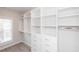 Walk-in closet featuring custom shelving and a window for natural light at 275 Briscoe Way # 3, Alpharetta, GA 30009