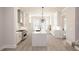 Well-lit kitchen with stainless steel appliances, white cabinets, a large island, and a view to the backyard at 275 Briscoe Way # 3, Alpharetta, GA 30009