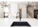 Open kitchen with white cabinets, stainless steel appliances, a kitchen island and a view of the staircase at 275 Briscoe Way # 3, Alpharetta, GA 30009