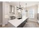 Bright kitchen features a large island, stainless steel appliances and modern pendant lighting at 275 Briscoe Way # 3, Alpharetta, GA 30009