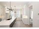 Bright kitchen boasts an island, stainless steel appliances and modern pendant lighting at 275 Briscoe Way # 3, Alpharetta, GA 30009