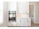 Kitchen cabinetry featuring a built-in double oven and ample storage, complemented by white countertops and modern design at 275 Briscoe Way # 3, Alpharetta, GA 30009