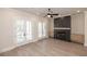 Bright living room with a fireplace, ceiling fan and double doors to the balcony at 275 Briscoe Way # 3, Alpharetta, GA 30009