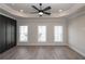 Spacious main bedroom with wood floors, recessed lighting, ceiling fan, and large windows at 275 Briscoe Way # 3, Alpharetta, GA 30009