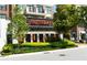 Street-level view of the Superica restaurant with lush landscaping and orange patio umbrellas at 275 Briscoe Way # 3, Alpharetta, GA 30009