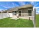 Exterior view of a fenced backyard with green grass and a neutral-colored home at 701 Bickmore Dr, Mcdonough, GA 30253