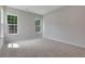 Bright and spacious bedroom featuring neutral walls, plush carpeting, and large windows for natural light at 701 Bickmore Dr, Mcdonough, GA 30253