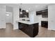 Modern kitchen featuring dark cabinets, granite countertops, stainless steel appliances, and a center island at 701 Bickmore Dr, Mcdonough, GA 30253