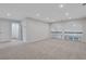 Spacious loft area with neutral walls and plush carpeting, perfect for a flexible living space at 701 Bickmore Dr, Mcdonough, GA 30253