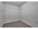 Spacious walk-in closet with wire shelving and soft carpeting, offering plenty of storage space at 701 Bickmore Dr, Mcdonough, GA 30253