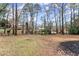 Expansive backyard with mature trees creates a private, natural setting at 743 Cedar Sw Trce, Lilburn, GA 30047