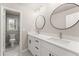 Bathroom boasts double sink vanity with modern faucets and fixtures and adjacent shower at 743 Cedar Sw Trce, Lilburn, GA 30047