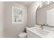 Bright half bathroom featuring modern fixtures and stylish finishes at 743 Cedar Sw Trce, Lilburn, GA 30047
