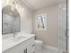 Bathroom features a marble shower with glass surround and sleek, modern vanity at 743 Cedar Sw Trce, Lilburn, GA 30047