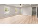 Bright bedroom featuring neutral walls, two windows, ceiling fan, and light wood-look flooring at 743 Cedar Sw Trce, Lilburn, GA 30047