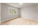 Bedroom featuring a light-filled window and light wood-look flooring at 743 Cedar Sw Trce, Lilburn, GA 30047