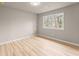 Bedroom featuring a light-filled window and light wood-look flooring at 743 Cedar Sw Trce, Lilburn, GA 30047