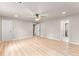 Bright bedroom with light wood-look floors, neutral walls, ceiling fan, and entry to bath at 743 Cedar Sw Trce, Lilburn, GA 30047