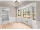 Bright dining area featuring a bay window, beautiful wood floors, decorative wall trim, and pantry at 743 Cedar Sw Trce, Lilburn, GA 30047