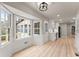 Bright dining area featuring a bay window, beautiful wood floors, and is connected to a modern kitchen at 743 Cedar Sw Trce, Lilburn, GA 30047