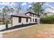 Two-story home with light-colored brick, brown shutters, manicured landscaping, and a welcoming front entrance at 743 Cedar Sw Trce, Lilburn, GA 30047