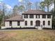 Charming two-story home with brown shutters, light-colored brick, manicured landscaping and a welcoming front entrance at 743 Cedar Sw Trce, Lilburn, GA 30047