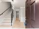 Inviting foyer with hardwood floors, staircase, and modern lighting fixtures offering a warm welcome at 743 Cedar Sw Trce, Lilburn, GA 30047