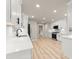 Modern kitchen featuring stainless steel appliances, white cabinets, light countertops, and wooden floors at 743 Cedar Sw Trce, Lilburn, GA 30047
