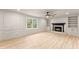 Spacious living room with fireplace, built-in shelving, and large windows at 743 Cedar Sw Trce, Lilburn, GA 30047