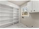 Large pantry featuring multiple shelves and drawers for organized storage with bright natural light at 743 Cedar Sw Trce, Lilburn, GA 30047