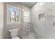 Shower with clear glass door and marble look tile surround at 743 Cedar Sw Trce, Lilburn, GA 30047