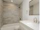 Bathroom with a white vanity, a tub with gray tile and a modern sink and mirror at 6350 Akins Way, Cumming, GA 30041